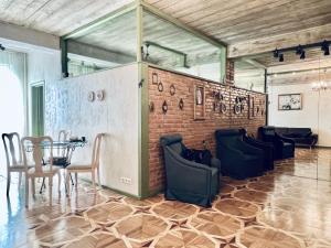 een kamer met stoelen en een bakstenen muur bij T2&T3 Apartments LEVANTO in Tbilisi City
