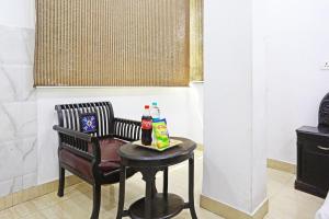 a table with two bottles of soda and a chair at Hotel Premium Room Near Hazrat Nizamuddin railway station in New Delhi