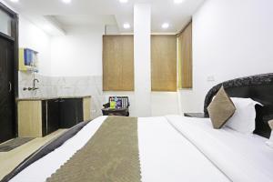 a bedroom with a large white bed in a room at Hotel Premium Room Near Hazrat Nizamuddin railway station in New Delhi