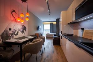 a kitchen with a table and chairs in a room at Apartamenty Panorama in Łódź