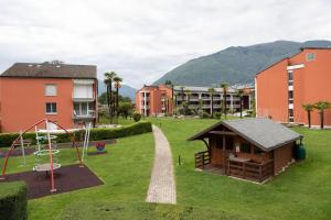 a playground with a gazebo and a swing at Casa Golf Ranch App 8000 in Ascona