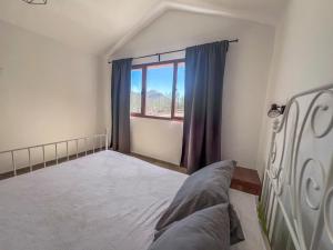 ein Schlafzimmer mit großem Bett und Fenster in der Unterkunft Vivelorural Abuela María 1, chill garden pool in San Bartolomé de Tirajana