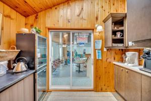 a kitchen with a sliding glass door to a dining room at Marmora and Lake Inn Superior Apartment- Sleeps 13 guests in Marmora