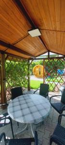 a patio with a table and chairs under a wooden roof at Willa Julia in Ustroń