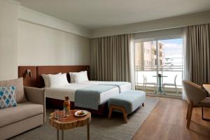 a hotel room with a bed and a couch at Dom Jose Beach Hotel (Plus) in Quarteira