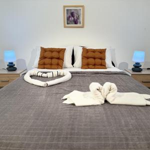 a bedroom with a bed with two towels on it at Villa Happy Family!!! in Prijevor
