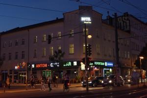 a building on the corner of a city street at night at Hotel Grand Inn Berlin - Weißensee in Berlin
