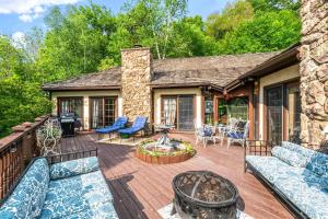 a patio with couches and a fire pit on a deck at Villa Sposa - Tranquil escape in the mountains in Roxbury