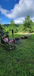 a group of chairs in the grass in a field at Villa Sposa - Tranquil escape in the mountains in Roxbury