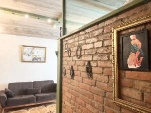 a living room with a brick wall and a couch at T2&T3 Apartments LEVANTO in Tbilisi City