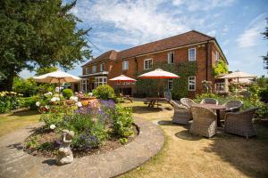 a garden with a table and chairs in front of a house at Bedford Arms Hotel in Rickmansworth