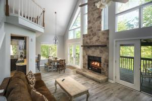 a living room with a couch and a fireplace at Autumn Breeze By Stony Brook Cabins in Gatlinburg