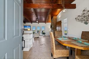 a kitchen and dining room with a table and chairs at Sunset Vista Beach House in Pensacola Beach