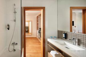 a bathroom with a sink and a shower at Dom Jose Beach Hotel (Plus) in Quarteira