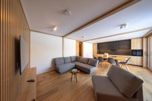 a living room with a couch and a table at House Natura Savica in Bohinj