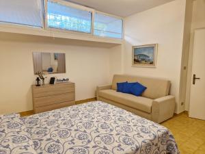 a bedroom with a bed and a couch at Total Relax Home by Holiday World in Framura