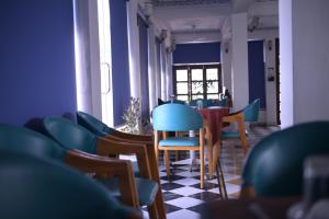 a dining room with blue chairs and a table at Hotel Darbargarh, Udaipur in Udaipur