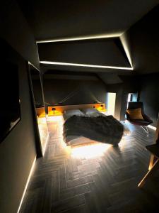 a bedroom with a bed in a dark room at Luxury Villa in Central Woodstock in Woodstock