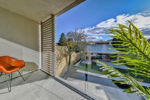 an orange chair sits on the balcony of a house at Luxury Villa in Central Woodstock in Woodstock