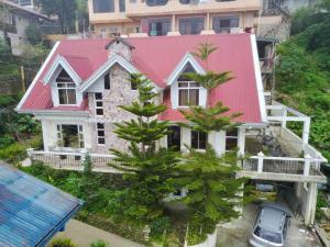 an aerial view of a house with a red roof at Guest Haven Chalet in Baguio