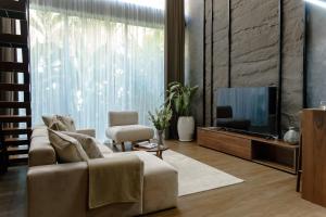 a living room with a couch and a tv at Sunny Cuddles in Canggu +152 photos