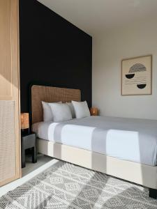 een slaapkamer met een wit bed en een zwarte muur bij 3 Room Luxury Design Apartment with Airconditioning, Close to Gent St-Pieters Station in Gent