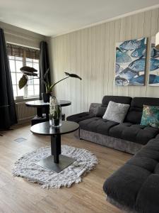 a living room with a couch and a table at Tour de la chaine, vieux port, Grand Appartement in La Rochelle