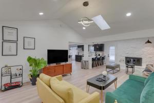 a living room with a couch and a tv at Texas Designer Home with Private Hot Tub and Pool in North Richland Hills