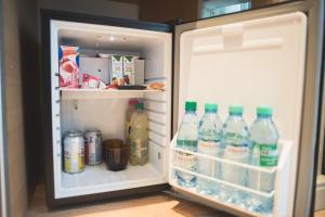 an open refrigerator filled with water and drinks at Amérian Catamarca Park Hotel in San Fernando del Valle de Catamarca