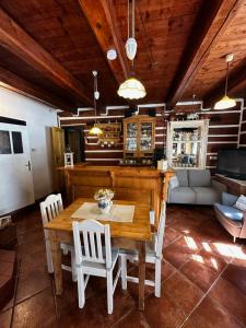 a dining room with a wooden table and chairs at Roubenka Volský Důl in Špindlerův Mlýn