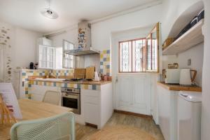 a kitchen with a sink and a stove top oven at Maison de village romantique in Cagnes-sur-Mer