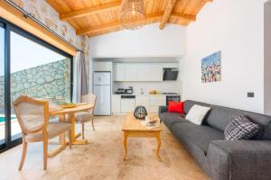 a living room with a couch and a table at Kalamar Beach 5 in Kaş