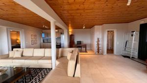 a living room with a couch and a table at The Edge Villa by KLV in Argostoli