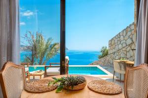 a dining table with a view of a swimming pool at Kalamar Beach 5 in Kaş +27 photos