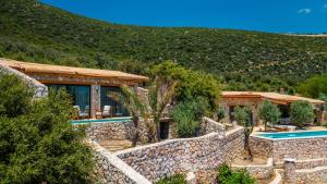 a villa with a swimming pool in front of a mountain at Kalamar Beach 5 in Kaş