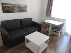 a living room with a couch and a table at Your Second Home-5 in Sindelfingen