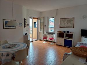 a living room with a table and chairs at Diana Cosy Apartment sea view near the beach in Monterosso al Mare