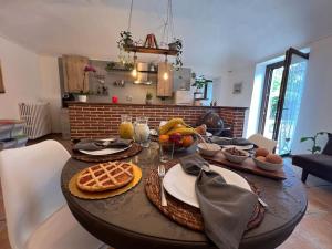 a wooden table with food on it in a living room at Casa Teddy Torino in Bosconero +14 photos
