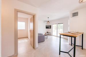 a living room with a table and a dining room at Yanka 4 Houses in Ljubaništa