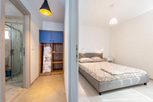a bedroom with a bed and a walk in closet at Yanka 4 Houses in Ljubaništa
