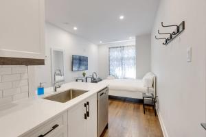 a white kitchen with a sink and a bed at M11 Upscale Studio wQueen Bed AC Prime Location in Montréal