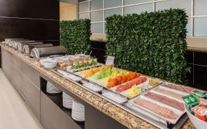 a buffet line in a hotel with vegetables and meats at NH Collection Monterrey San Pedro in Monterrey
