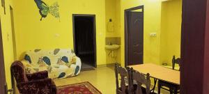 a living room with a couch and a table and a sink at Pebbles in Kozhikode