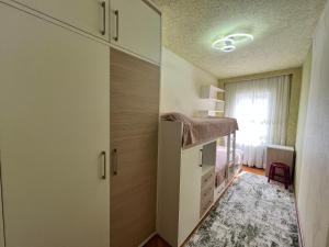 a small bedroom with a bed and a closet at Cozy apartment in Baku