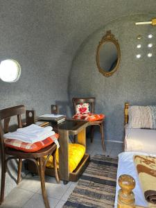 a room with a table and chairs and a bed at Camping Lukač in Kutina
