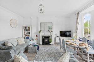 a living room with a couch and a table at Anchor Watch with Parking in Dartmouth