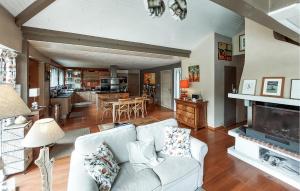 a living room with a white couch and a fireplace at Stunning Home In Seignosse in Seignosse