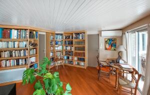a room with book shelves and a desk with a laptop at Stunning Home In Seignosse in Seignosse +16 photos