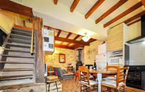 a kitchen and dining room with a table and a staircase at Lovely Home In Seix With Wifi in Seix