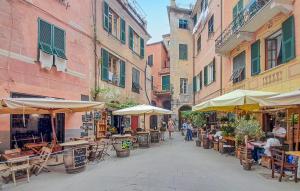 a street with tables and chairs and umbrellas at Pet Friendly Apartment in Monterosso al Mare +11 photos